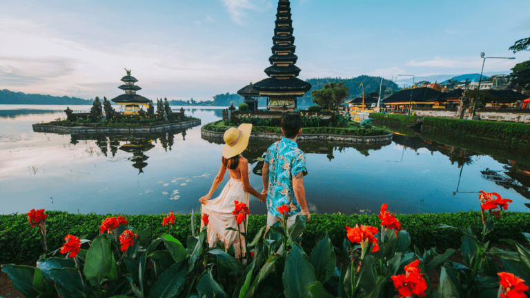 Tourists exploring a serene temple in Bali, highlighting travel tips including how to extend visa in Bali.